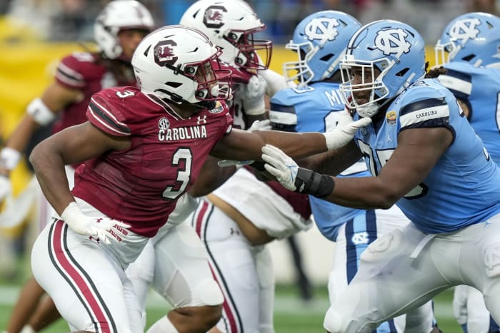 Dec 30, 2021; Charlotte, NC, USA; South Carolina Gamecocks defensive end Jordan Burch (3) tries to evade North Carolina Tar Heels offensive lineman Joshua Ezeudu (75) during the second quarter at Bank of America Stadium.